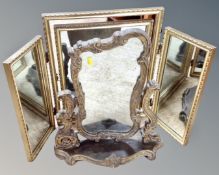 A gilt Rococo style dressing table mirror on stand together with a further gilt triple dressing