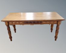 An Edwardian oak library table fitted a drawer