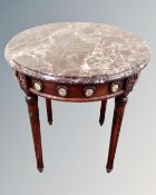 A French style marble topped circular occasional table with porcelain mounts.