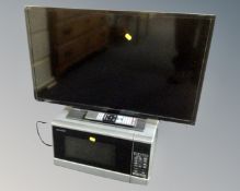 A Toshiba 32" LCD Smart TV, together with a Sharp microwave.