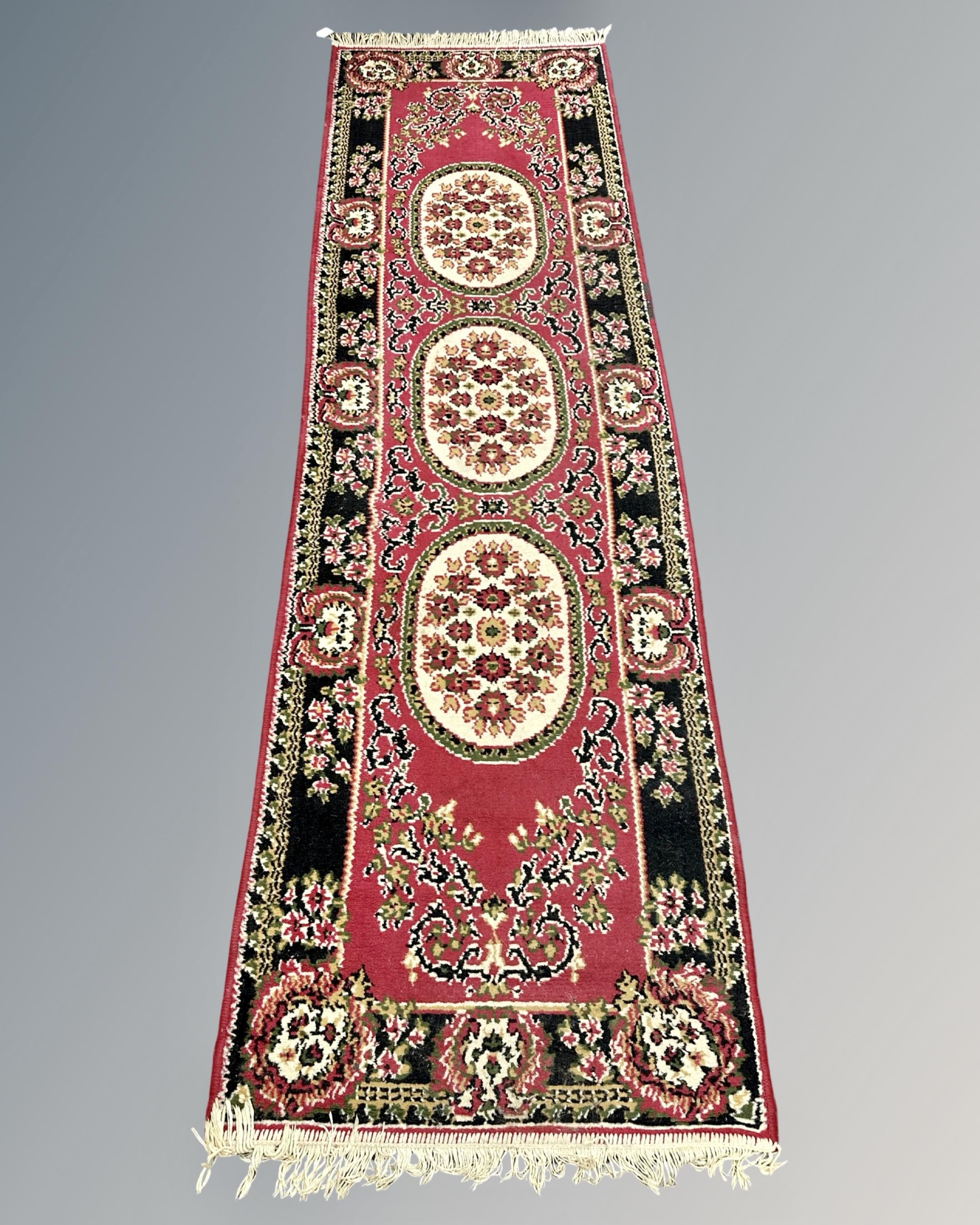 A Persian design runner, 70cm by 252cm.