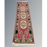 A Persian design runner, 70cm by 252cm.