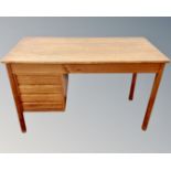 A Scandinavian teak single pedestal writing desk fitted with four drawers.