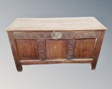 An early 19th century panelled oak coffer.