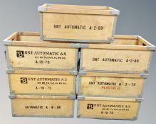 Seven stackable wooden and metal bound crates