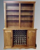 A contemporary mahogany Welsh dresser with cupboards and wine rack beneath