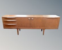 A 20th century McIntosh teak low sideboard fitted with cupboards and drawers.