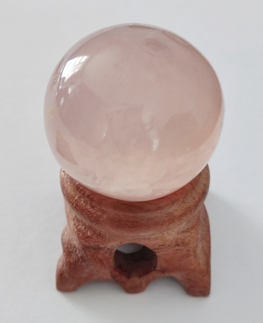 Natural pink Rose Quartz crystal sphere and stand.