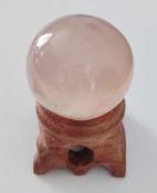 Natural pink Rose Quartz crystal sphere and stand.
