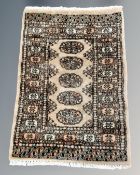 A Lahore Bokhara rug, Pakistan, on coffee ground, 98cm by 65cm.