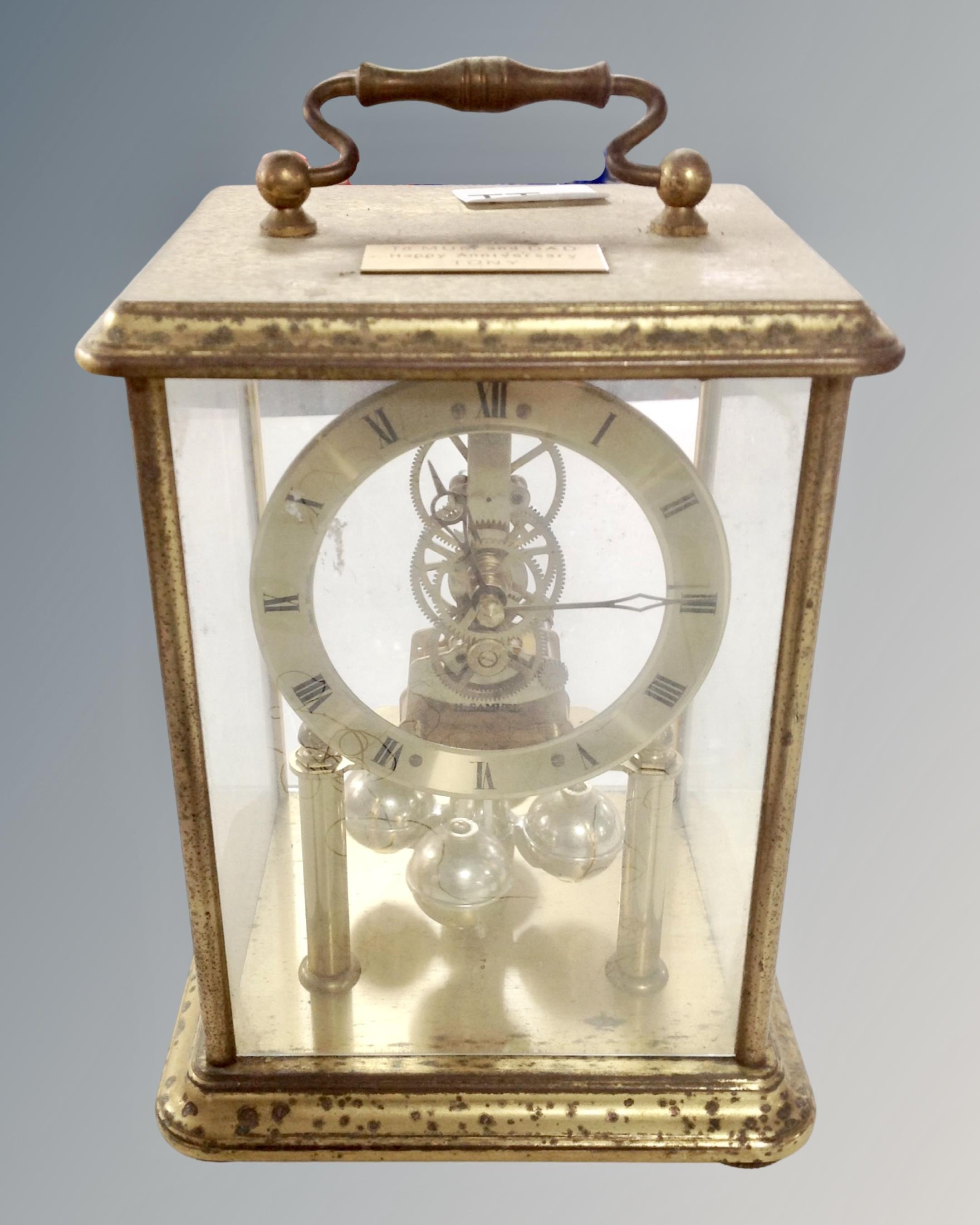 A brass cased anniversary clock.