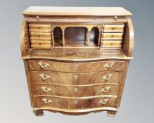 A Scandinavian beech serpentine cylinder front writing bureau fitted with four drawers.