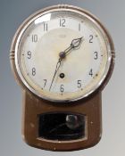 A 1930s Smiths Enfield metal cased wall clock with key.