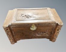 A carved camphor wood blanket chest.