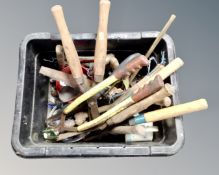 A tub containing a large quantity of assorted hand tools and gardening tools.