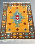 A Caucasian design rug on yellow ground, 128cm by 170cm.