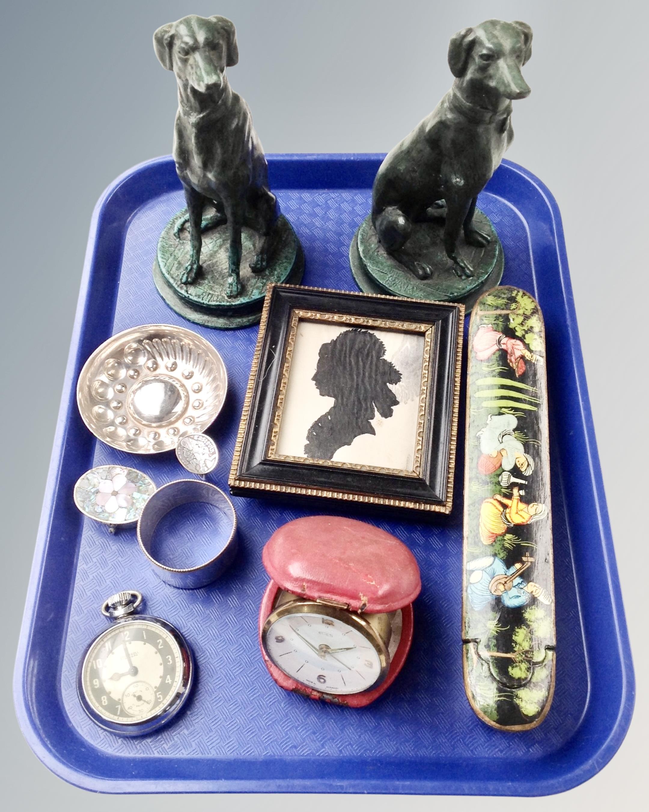 A tray containing an Asian white metal wine taster, plated napkin ring, travel clock,