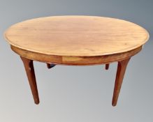 A mahogany oval low coffee table.