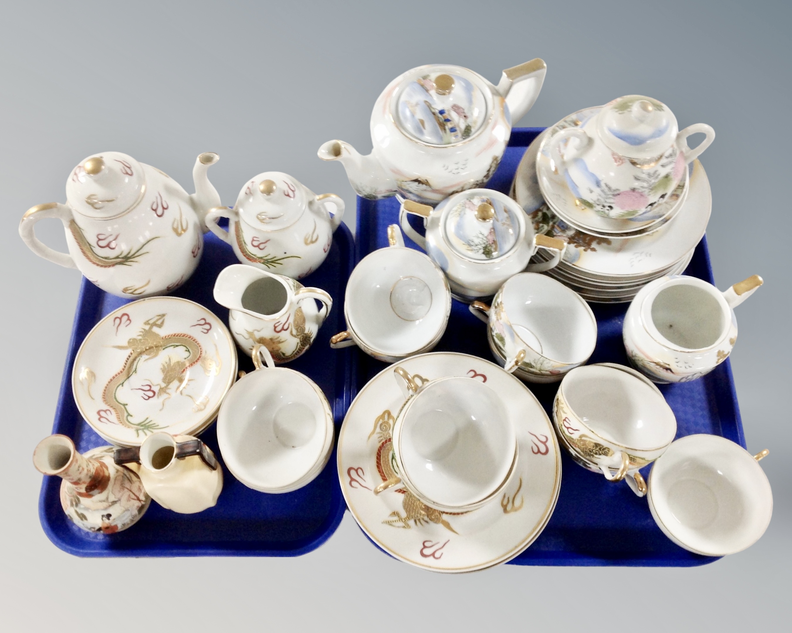 Two trays of two part Japanese gilded tea services together with a Japanese satsuma vase and a twin