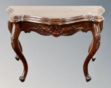 A reproduction shaped console table on cabriole legs.
