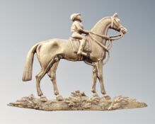 A brass flat backed figure of a horse and jockey.