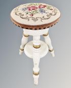 A 19th century cream and gilt circular piano stool.