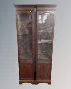A pair of glazed mahogany sentry door cabinets.