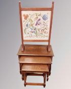 A nest of three oak tables and a tapestry fire screen