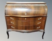 A Scandinavian serpentine front cylinder bureau fitted with three drawers beneath.