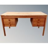 A Scandinavian teak twin pedestal writing desk fitted with six drawers.