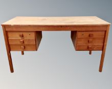A Scandinavian teak twin pedestal writing desk fitted with six drawers.