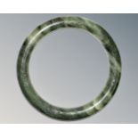 A carved jade circular bangle, inner diameter 58mm.