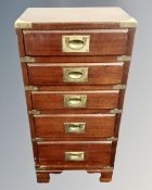 A campaign style five drawer chest with brass drop handles.