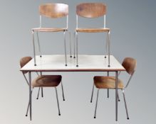 A Scandinavian melamine topped rectangular dining table together with a set of four chairs.