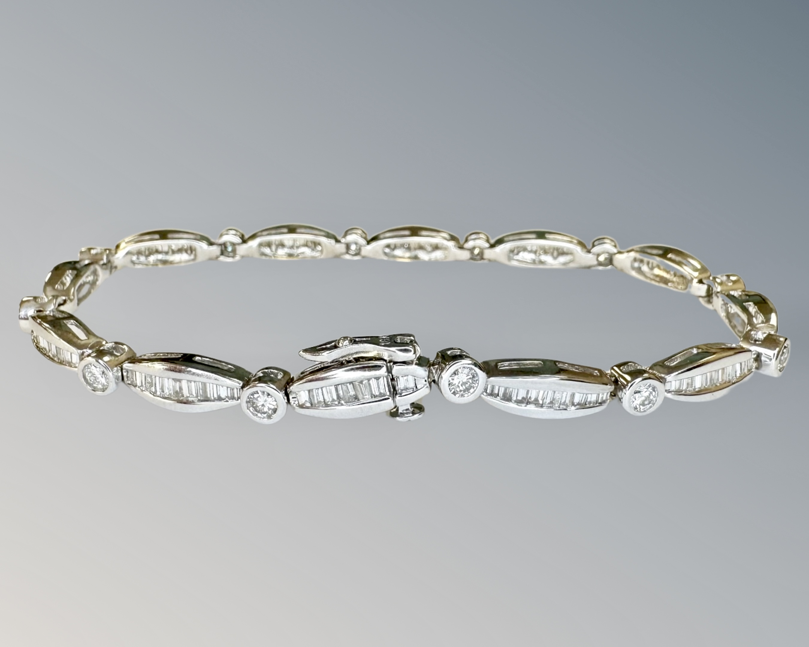 A 18ct white gold diamond bracelet set round and baguette stones, approximately 117 stones,