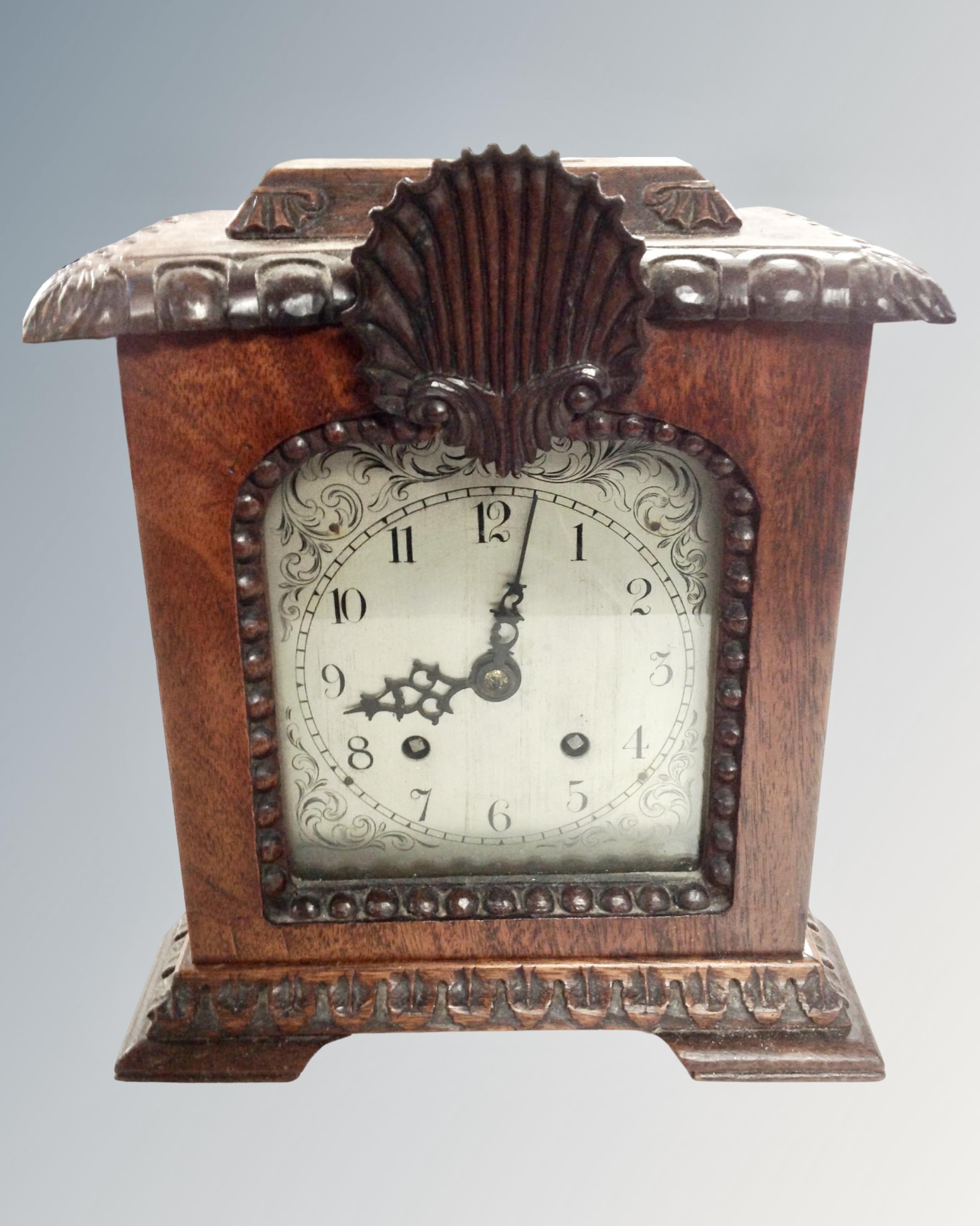An antique mahogany cased bracket clock with silvered dial.