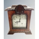 An antique mahogany cased bracket clock with silvered dial.