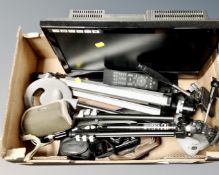 A box containing a miniature metal detector, cameras, camera tripods,
