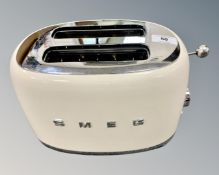 A SMEG model 870-1035W twin-slot toaster in cream finish
