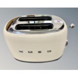 A SMEG model 870-1035W twin-slot toaster in cream finish