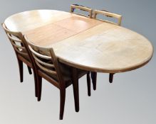 A 20th century oval teak G-Plan extending dining table and four ladder back chairs