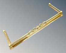 A Victorian brass extending fire curb.