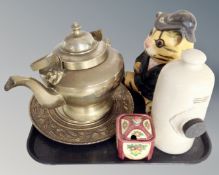 A tray containing a brass lion mask teapot together with a brass embossed plaque,