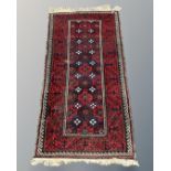 An Afghan rug, 92cm by 187cm.