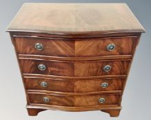 A reproduction mahogany bow fronted chest of four drawers.