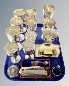 A tray containing assorted plated goblets, plated cutlery, a Super Chromonica harmonica in case,