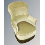 An early 20th century salon armchair upholstered in green dralon.