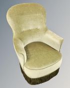 An early 20th century salon armchair upholstered in green dralon.
