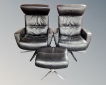 A pair of Comfort of Norway black stitched leather swivel armchairs on four way chrome supports,