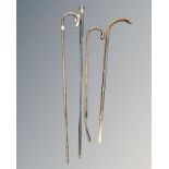 Three antique walking sticks including two silver-mounted examples,